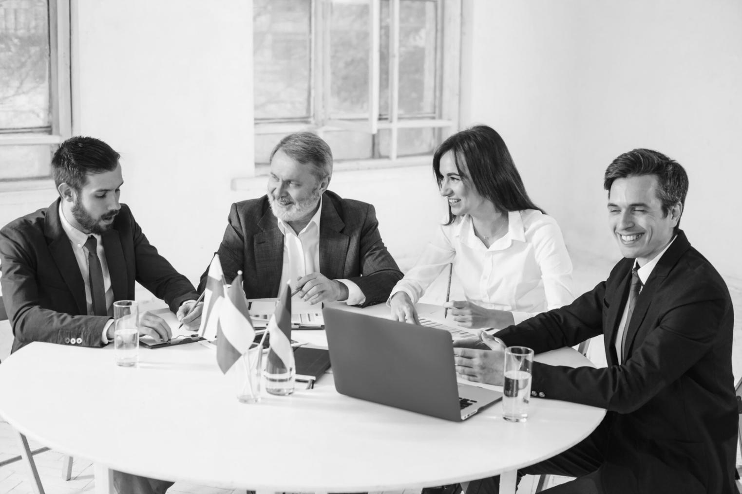 International students collaborating on financial analysis project in modern classroom setting